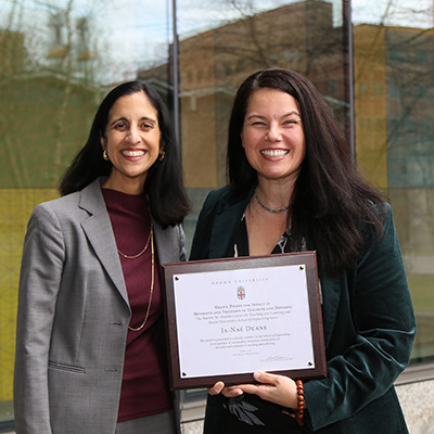 Dean Tejal Desai and Ja-Nae Duane holding award