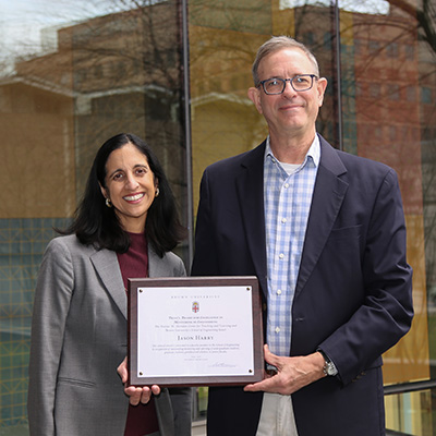 Dean Tejal Desai and Jason Harry holding award